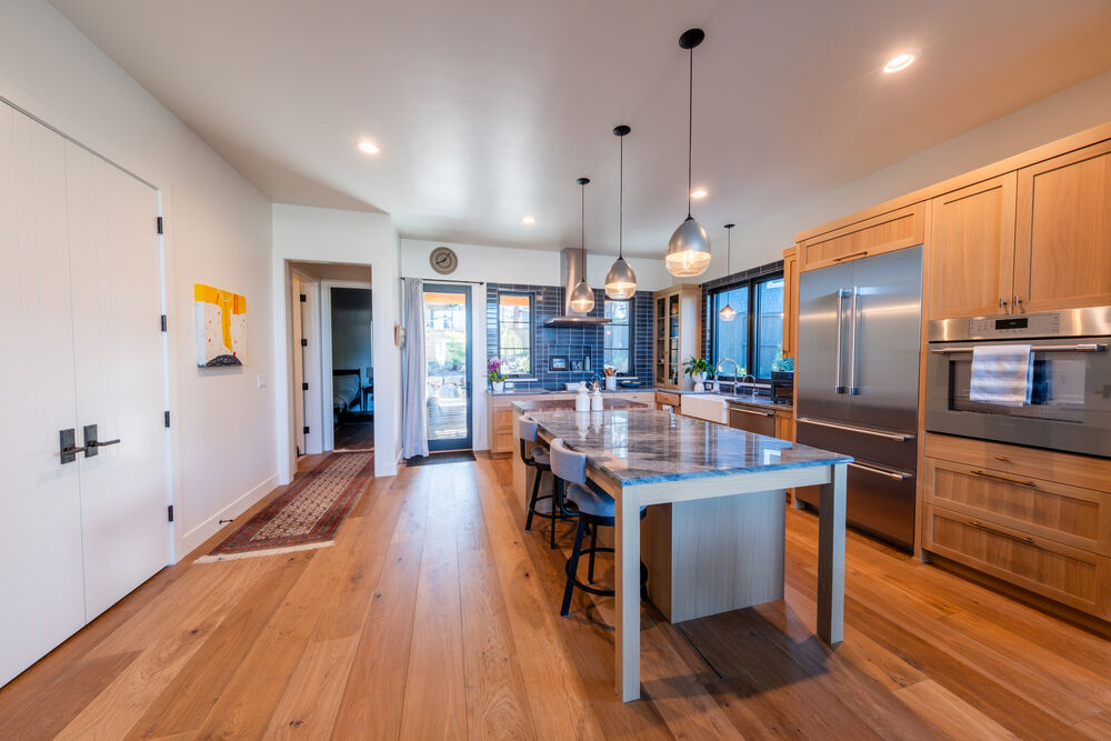 Open-concept great room with vaulted ceiling and Cascade-facing windows