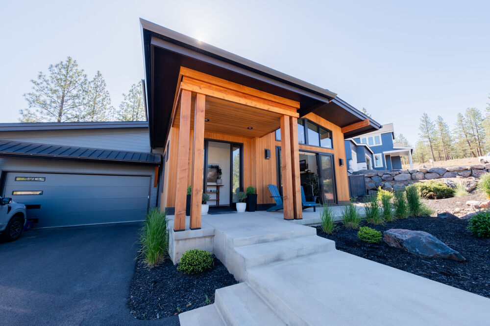 Twilight exterior with covered patio and warm wood detailing